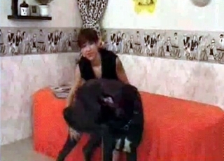Clothed brown-haired enjoying a dark-hued hound