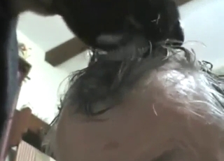 Guy lets the dog lick his head to get harder