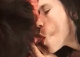 Brunette playfully sucking dog's cock